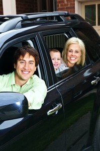 Happy family in car - Man, wife and son